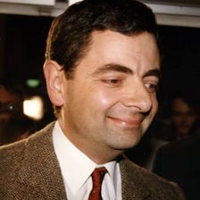 Rowan Atkinson portraying the character Mr. Bean.