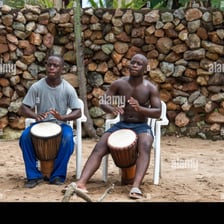A musician playing a pair of bongo drums.