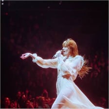 Florence Welch singing onstage with Florence + the Machine