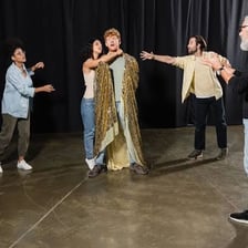 Performers rehearsing a scene before the actual performance.
