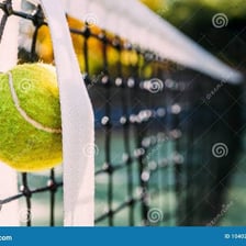 A tennis ball resting in the net after a serve