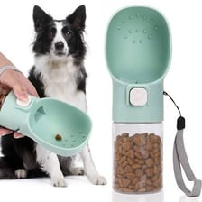 A person holding a small treat while training a dog