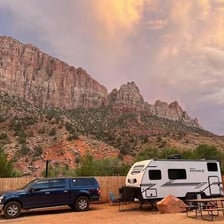 A recreational vehicle parked at a campground in a national park