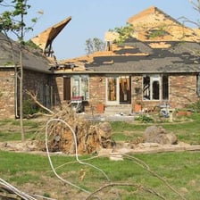 A tornado-damaged building with its roof torn away.