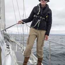 A person looking uncertain while aboard a sailboat