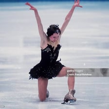 Oksana Baiul performing a figure-skating routine.