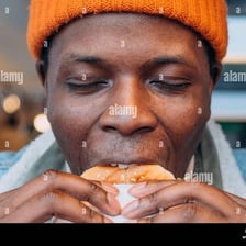 A person pausing to enjoy a bite of food.