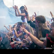 A crowd of enthusiastic fans at a music concert.