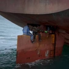 A person concealed among cargo, illustrating a stowaway.