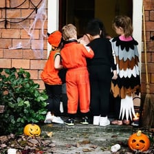 Children in costumes participating in Halloween trick-or-treating.
