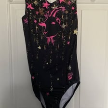 Simone Biles wearing a leotard featuring a goat design