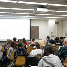 A college student sitting in a classroom lecture