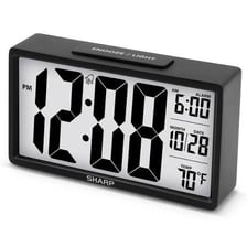 A digital alarm clock with an AM or PM indicator lit beside the time.