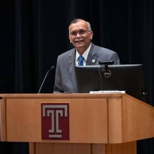 A university dean speaking to students at a campus event.