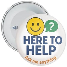 A tour guide wearing a badge that says “Ask Me”
