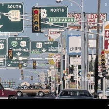A roadway lined with visible traffic signs.