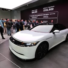 A vehicle presented with a model-year designation in an automobile showroom.