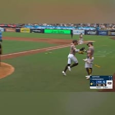 A baseball runner scoring from third base on a fly ball.