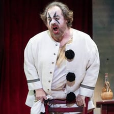 A performer portraying Tonio in a stage production of *Pagliacci*.