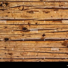 A weathered wooden surface showing wear from use.