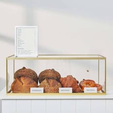 An assortment of pastries displayed in a bakery case