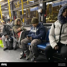 A passenger seated on a city bus