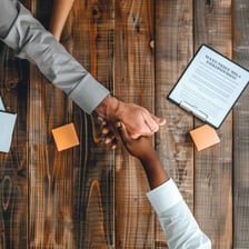 Businesspeople completing a corporate acquisition with signed documents