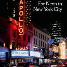 Colorful neon signs illuminating Times Square in New York City.