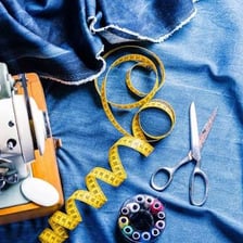 A tailor sewing a garment during an alteration.
