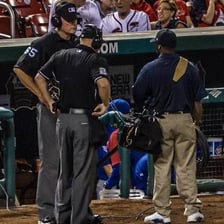 A sports referee watching an instant replay screen