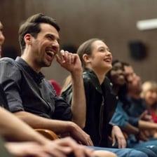 An audience laughing during a comedy performance.