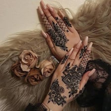 An intricate henna design covering part of a hand.