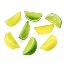 A lemon wedge resting on the rim of a cocktail glass
