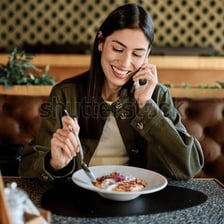 A person consuming a meal at a table