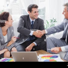 People nodding in agreement around a meeting table.
