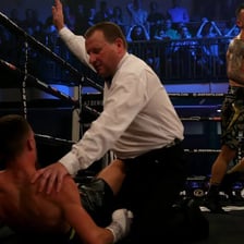 A boxing referee stopping a match