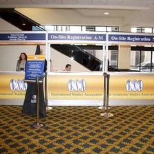 A convention registration desk where attendees check in.