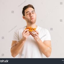 A person smiling while tasting appealing food