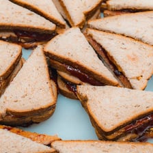 A peanut butter and jelly sandwich cut in half