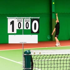 A tennis scoreboard displaying set scores.