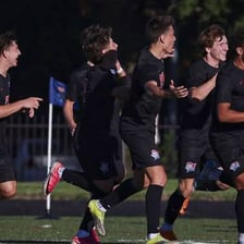 A team celebrates after scoring a decisive point.