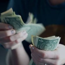 A person handing money back to another person