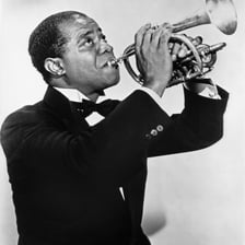 Louis Armstrong performing with a trumpet.
