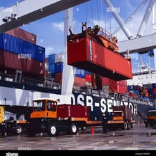 Cargo containers being inspected at a port customs facility.