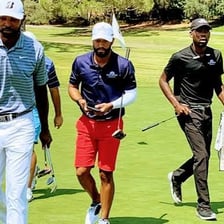 Professional and amateur golfers competing in a tournament.