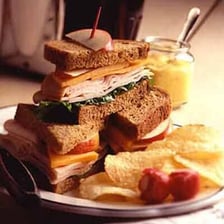 A deli sandwich served on slices of rye bread.
