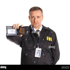An FBI agent holding up an identification badge