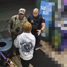 A police officer taking a suspect into custody