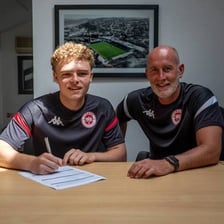 An athlete signing a contract to become a professional