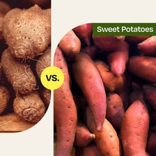 Fresh yams displayed beside sweet potatoes